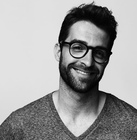 Black and white image of a man smiling at the camera